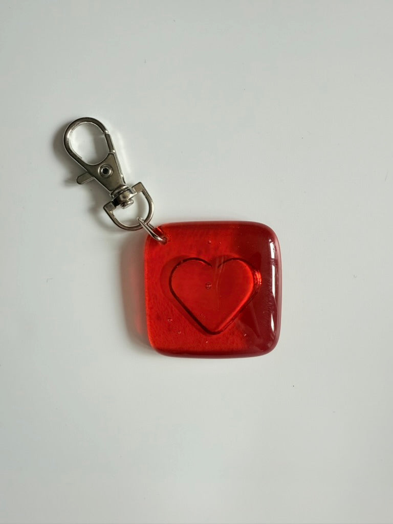 Red square keychain with a heart cutout