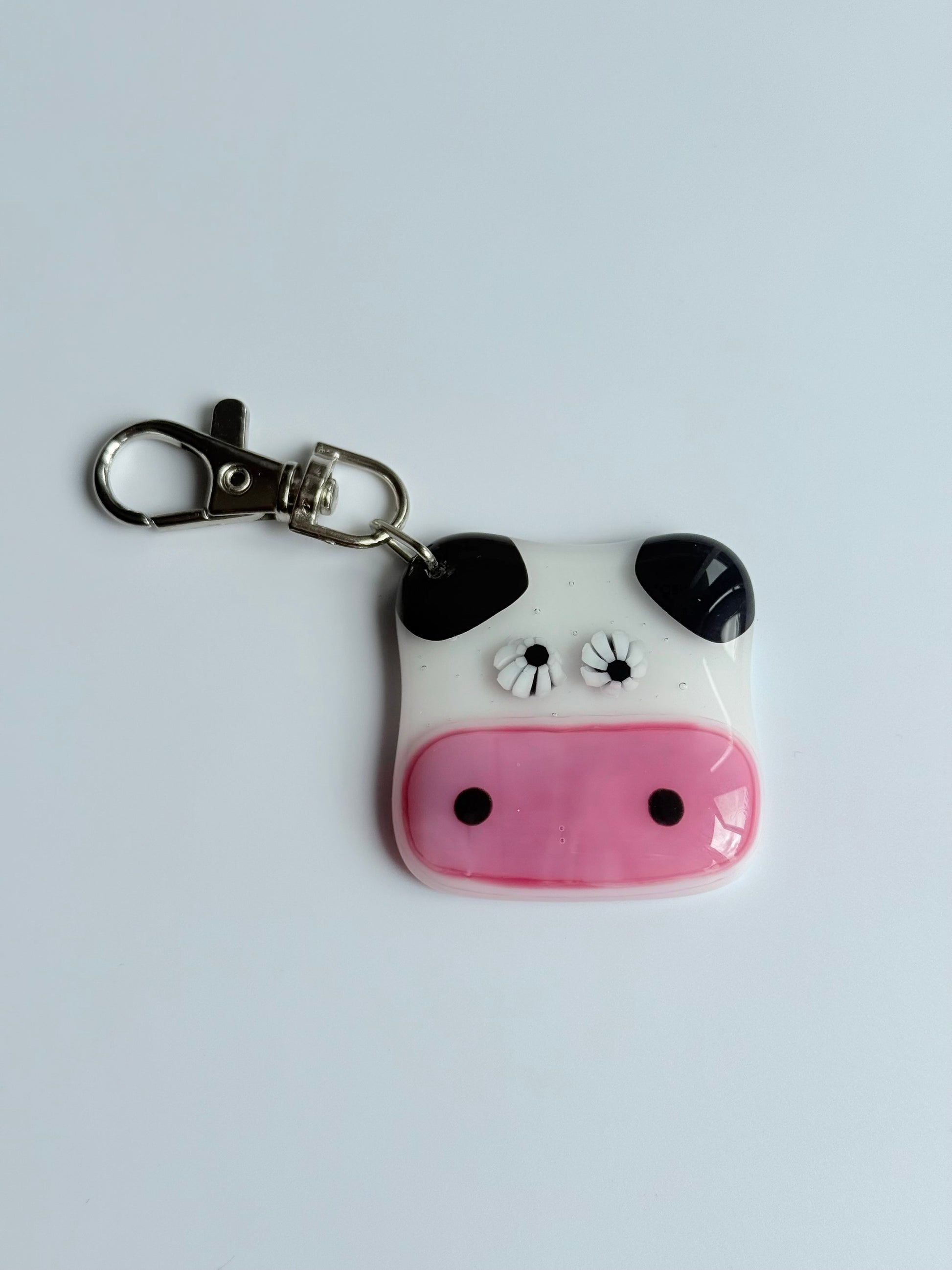Keychain with a cow design on a light gray background